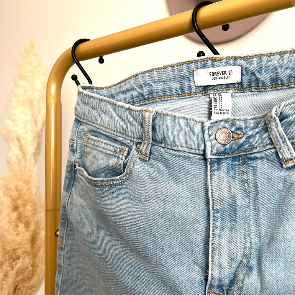 Forever 21 jeans light wash jeans distressed on both sides of the pant legs -